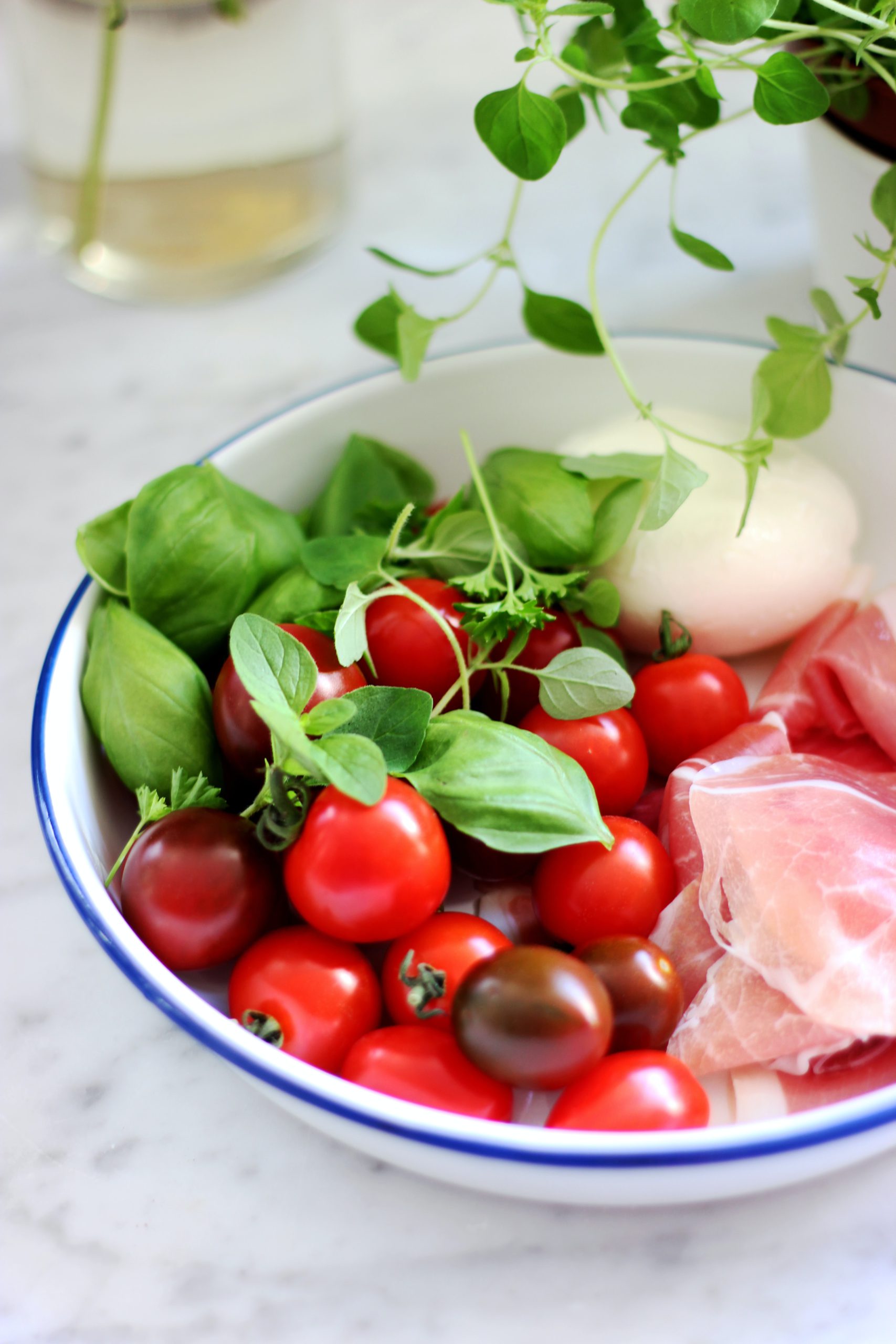 bowl with prosciutto, tomatoes, basil, and burrata