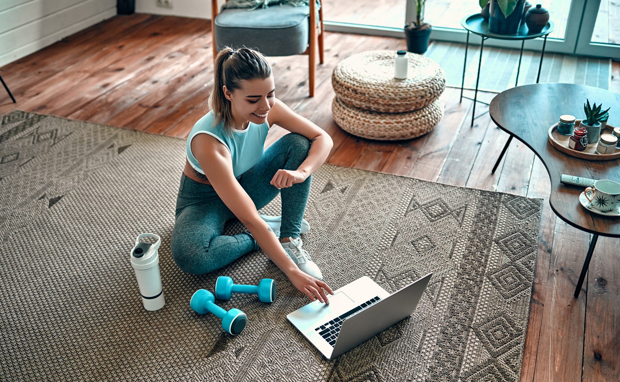 woman working out with laptop
