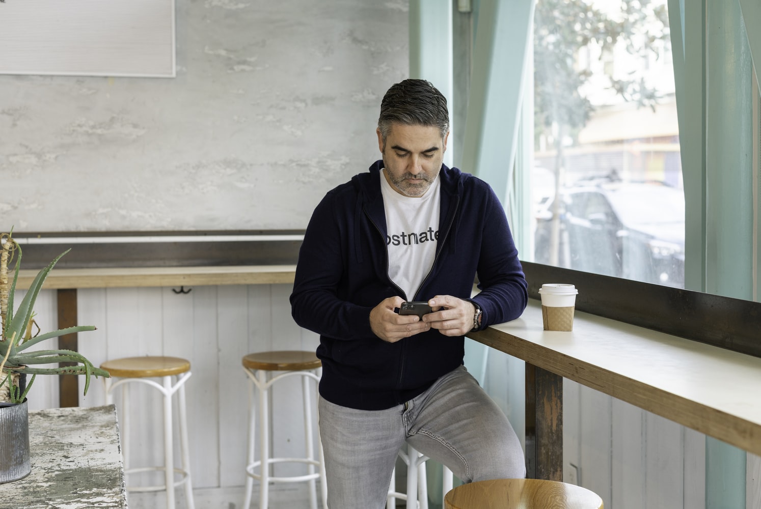 man in coffee shop on phone