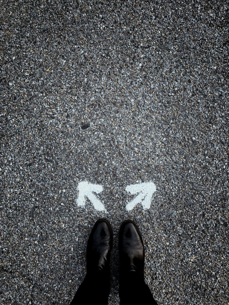 feet in front of arrows pointing in opposite directions