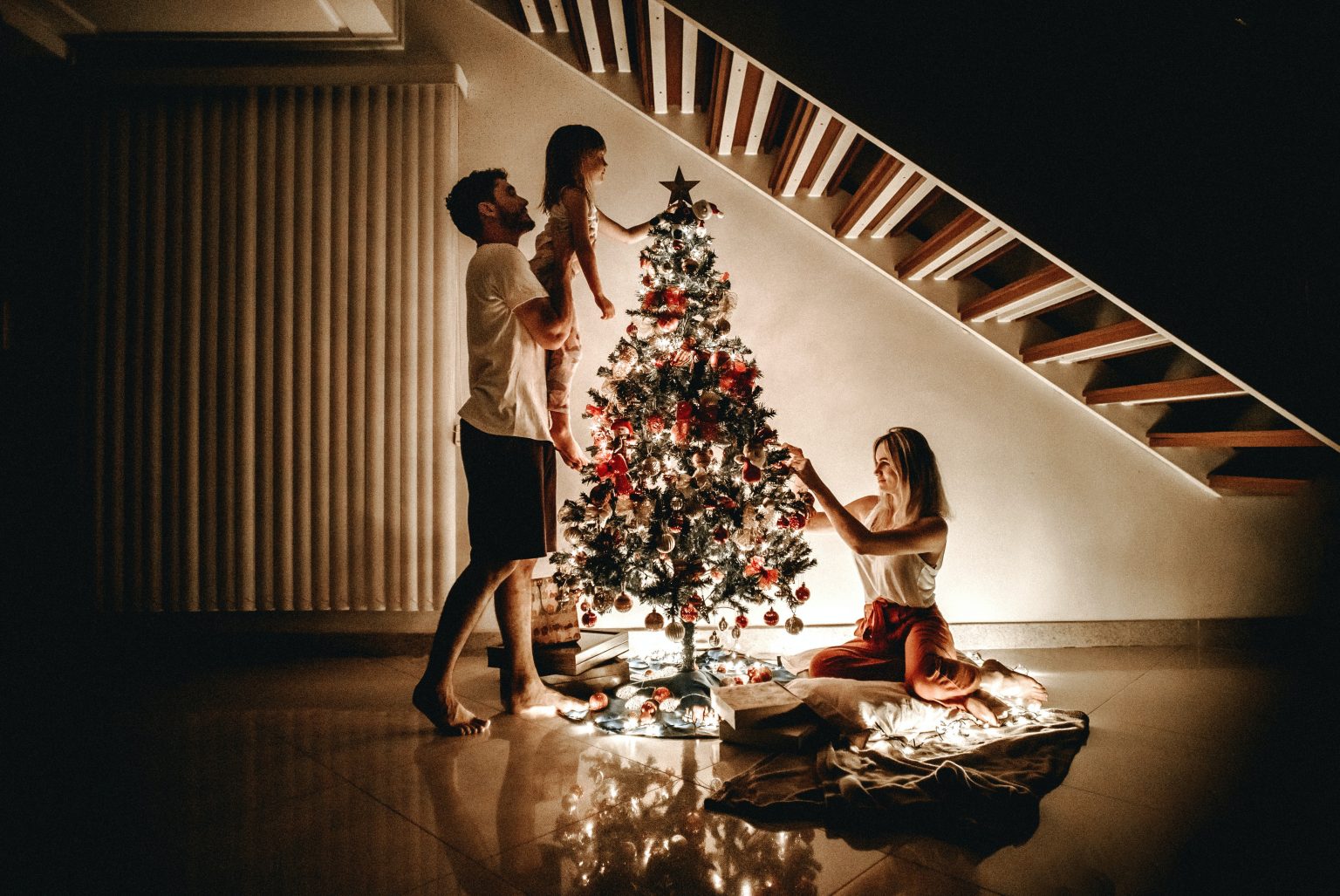 family putting up a christmas tree