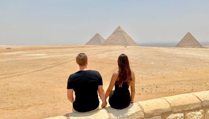 two people looking at the pyramids of Giza