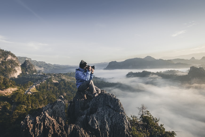 taking a photograph on top of a mountain