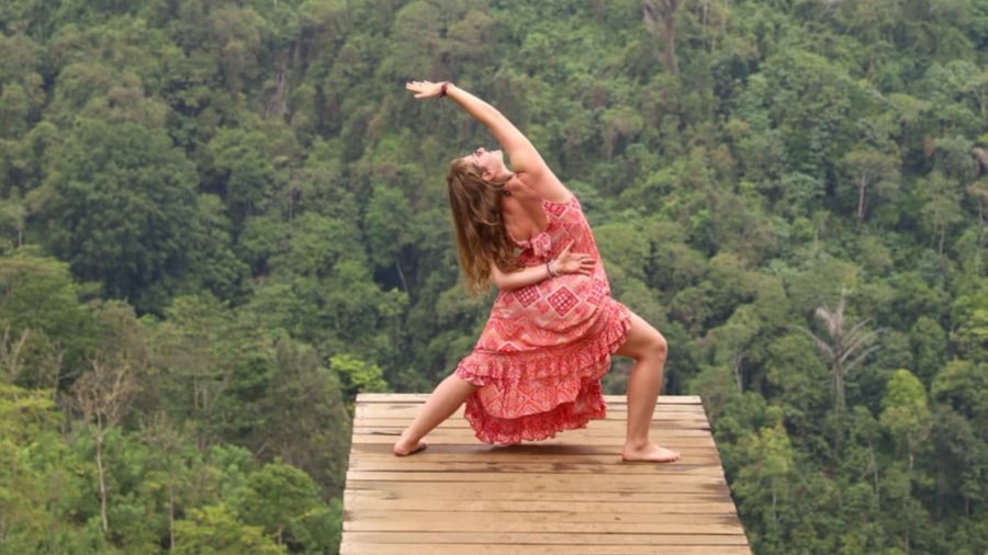 woman doing yoga on a ledge