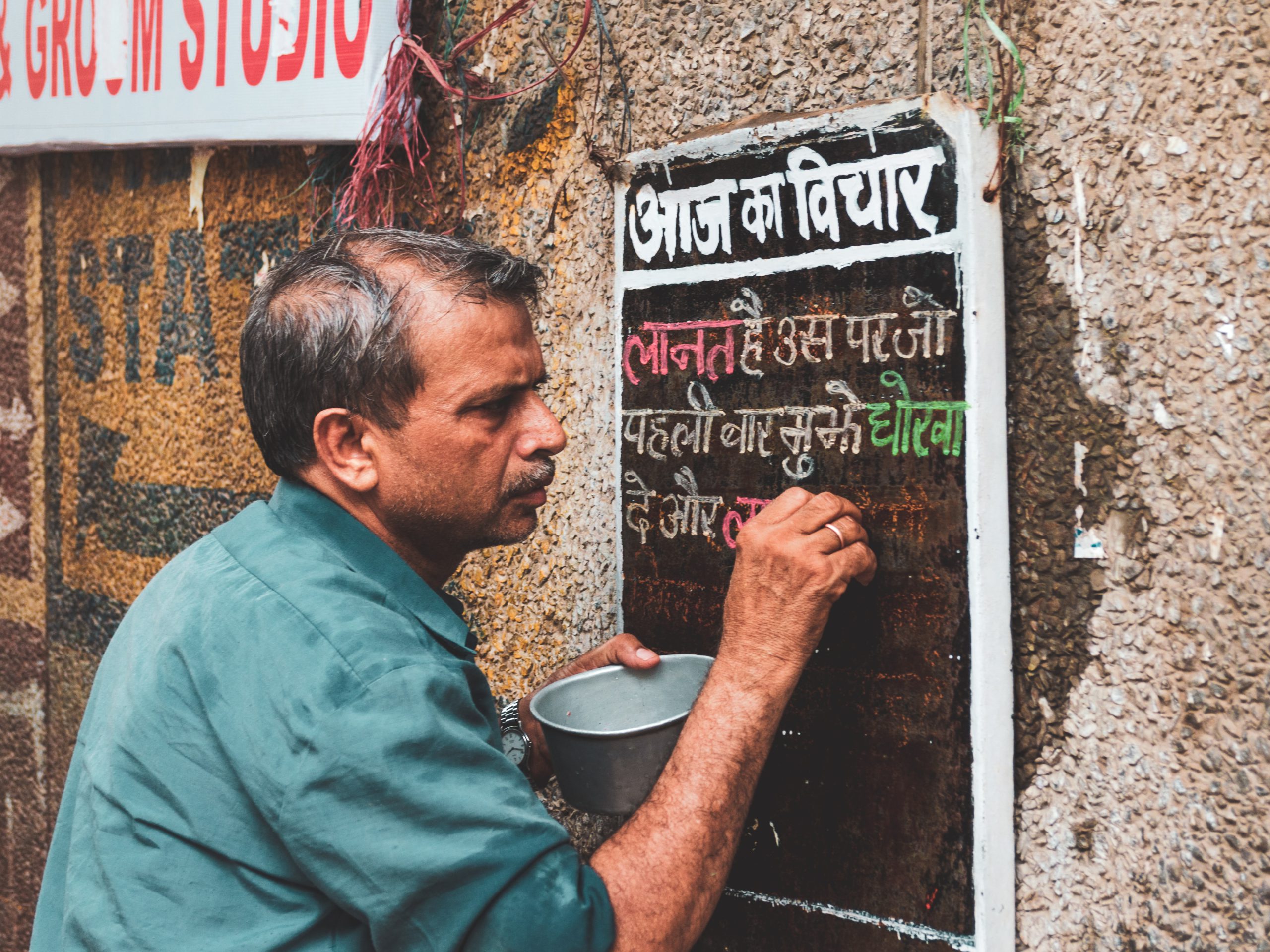 man writing sign in hindi