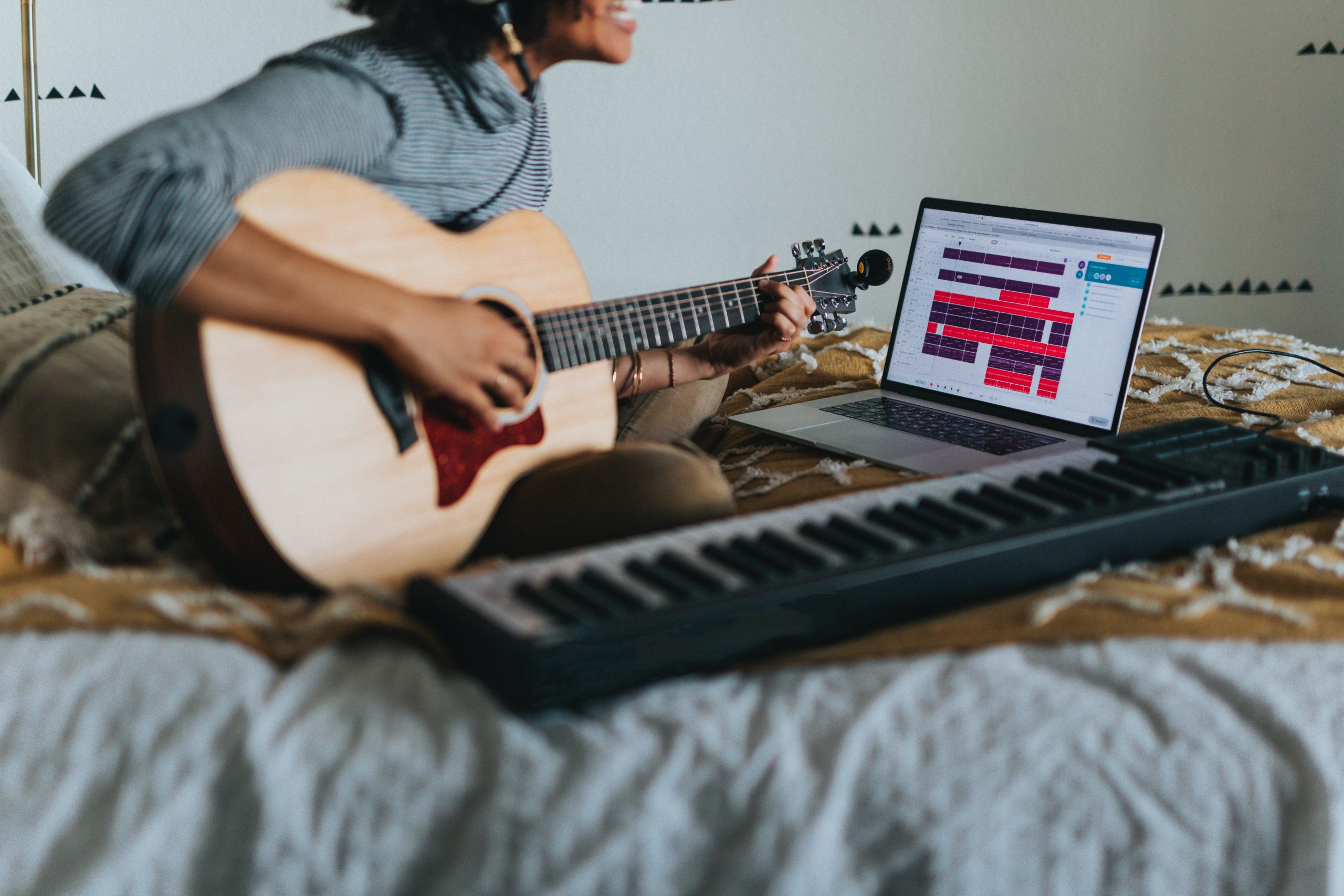 man in grey shirt playing guitar tab