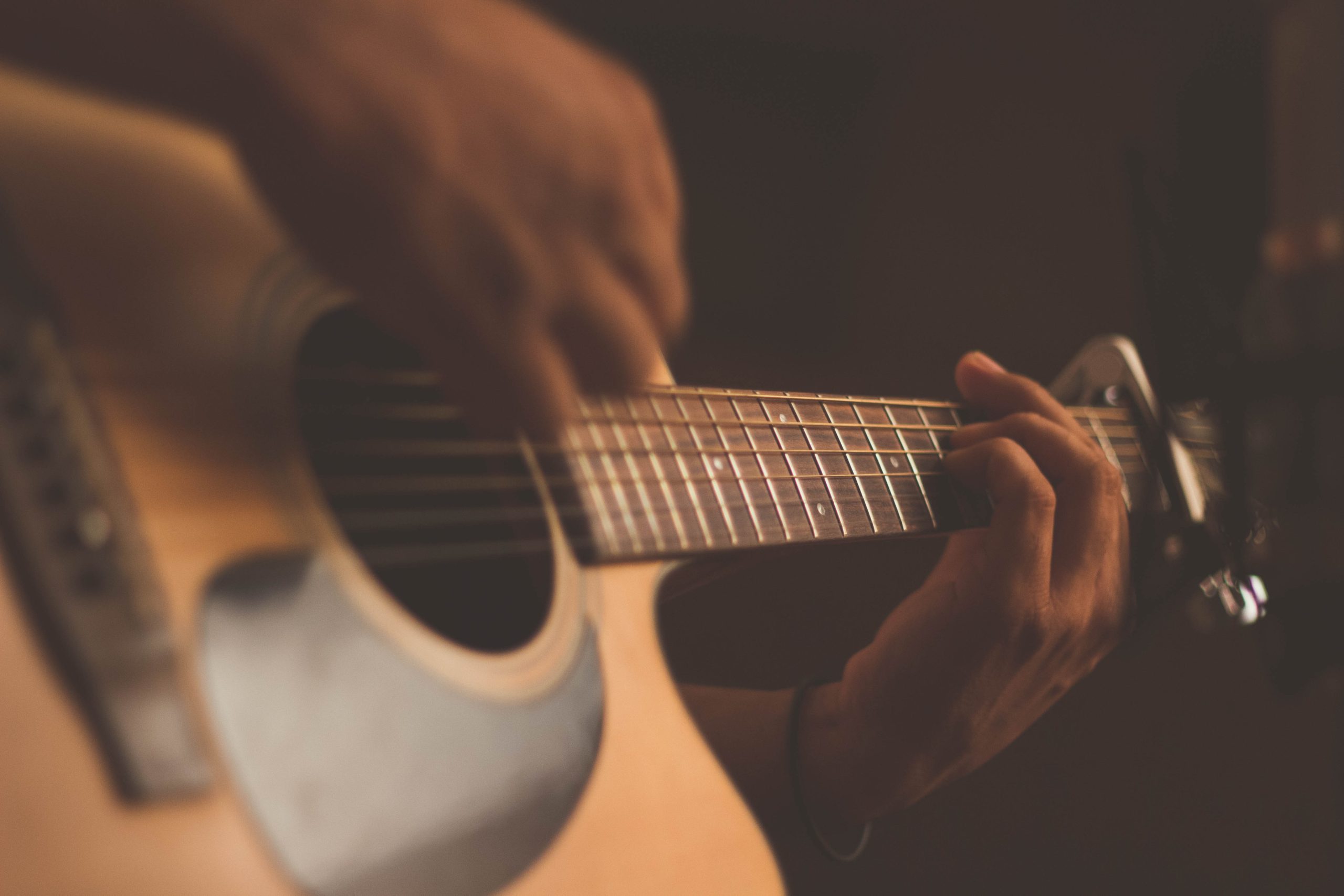 man playing acoustic