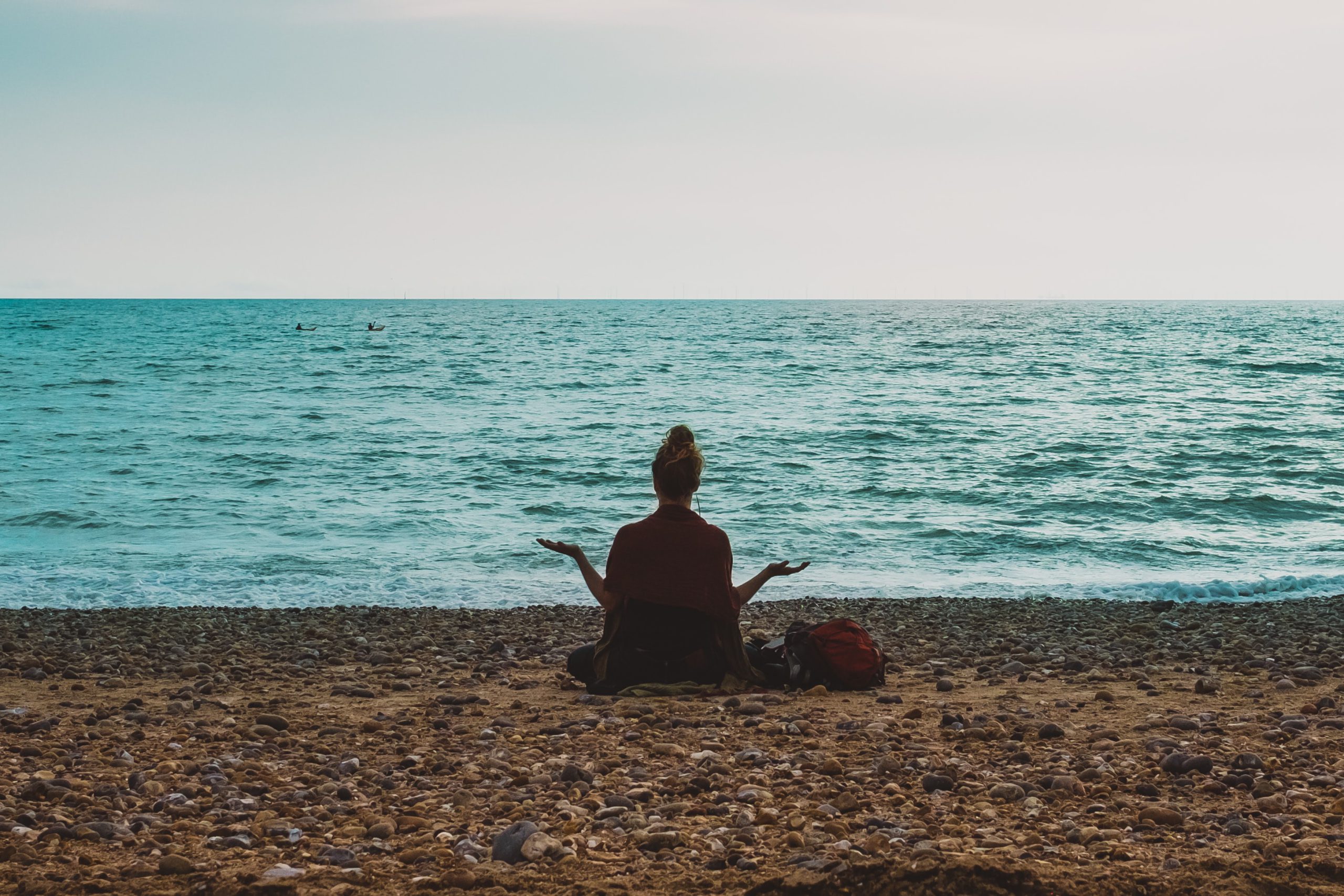 woman meditating on a beach