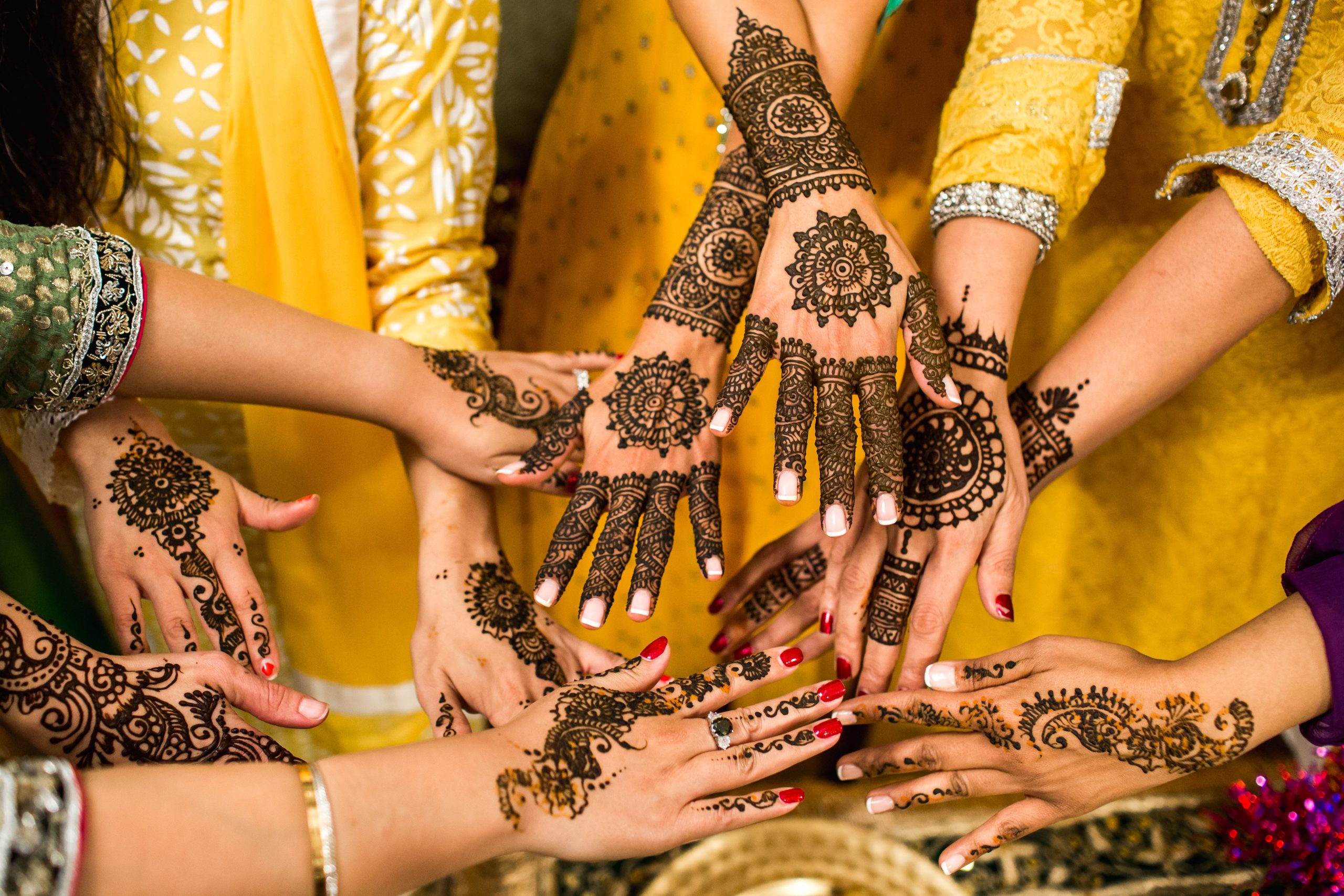 women with henna on their hands