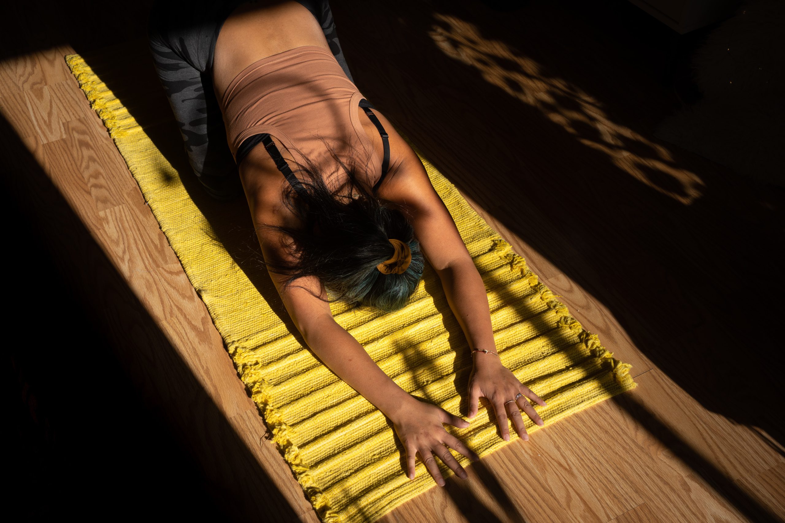 woman stretching on yellow mat