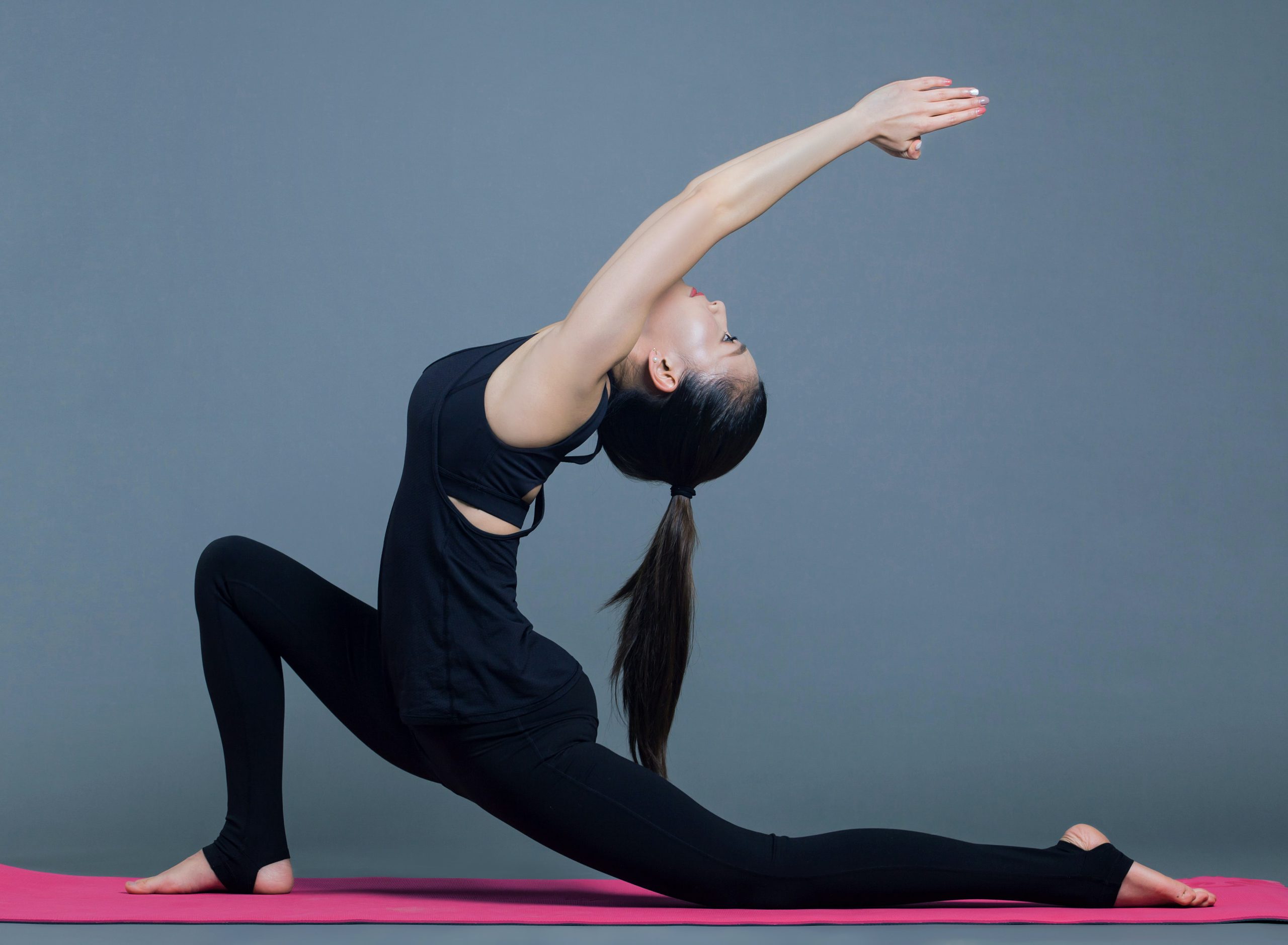 woman in black doing yoga