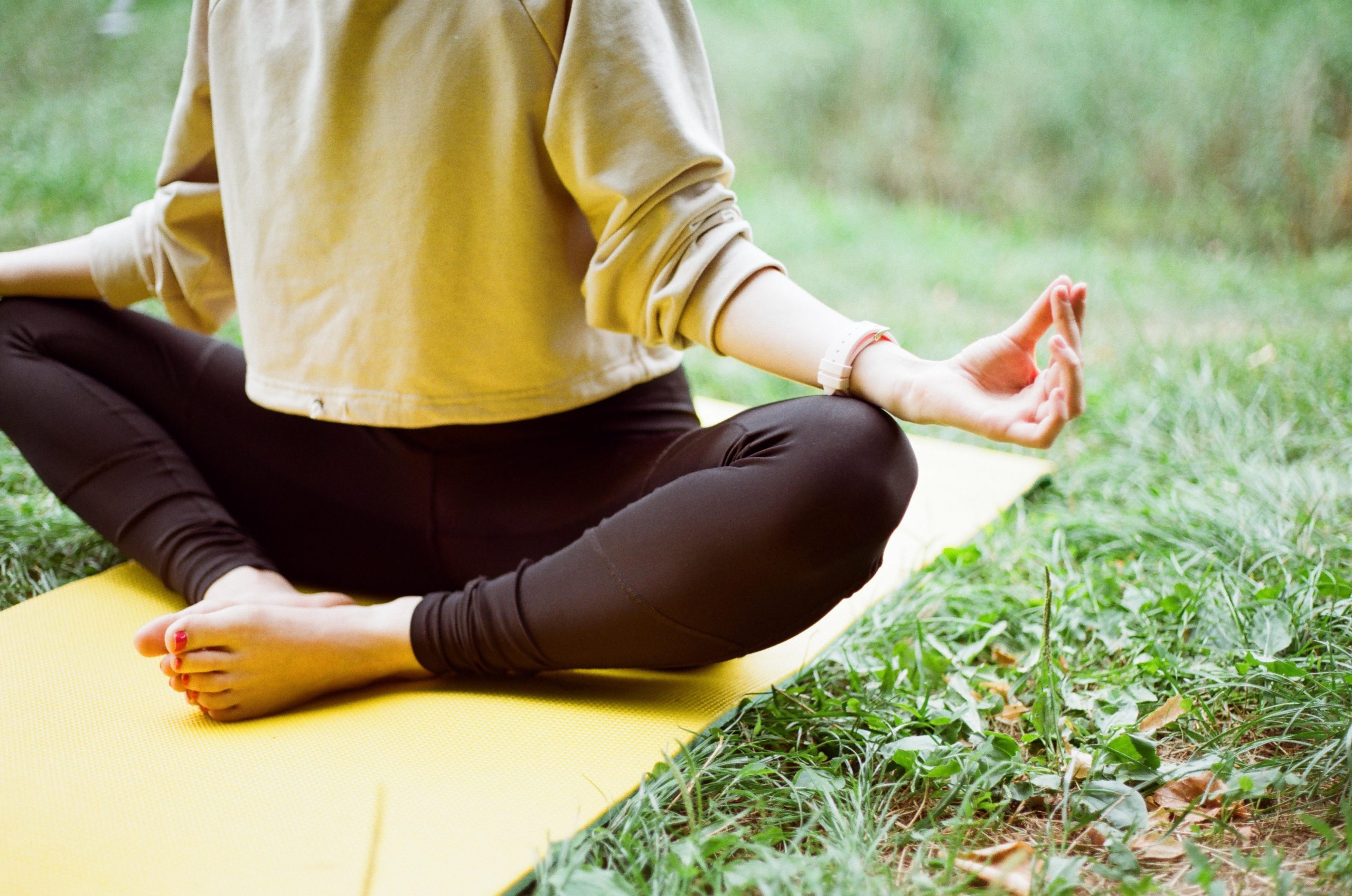 woman in brown long sleeve shirt doing yoga