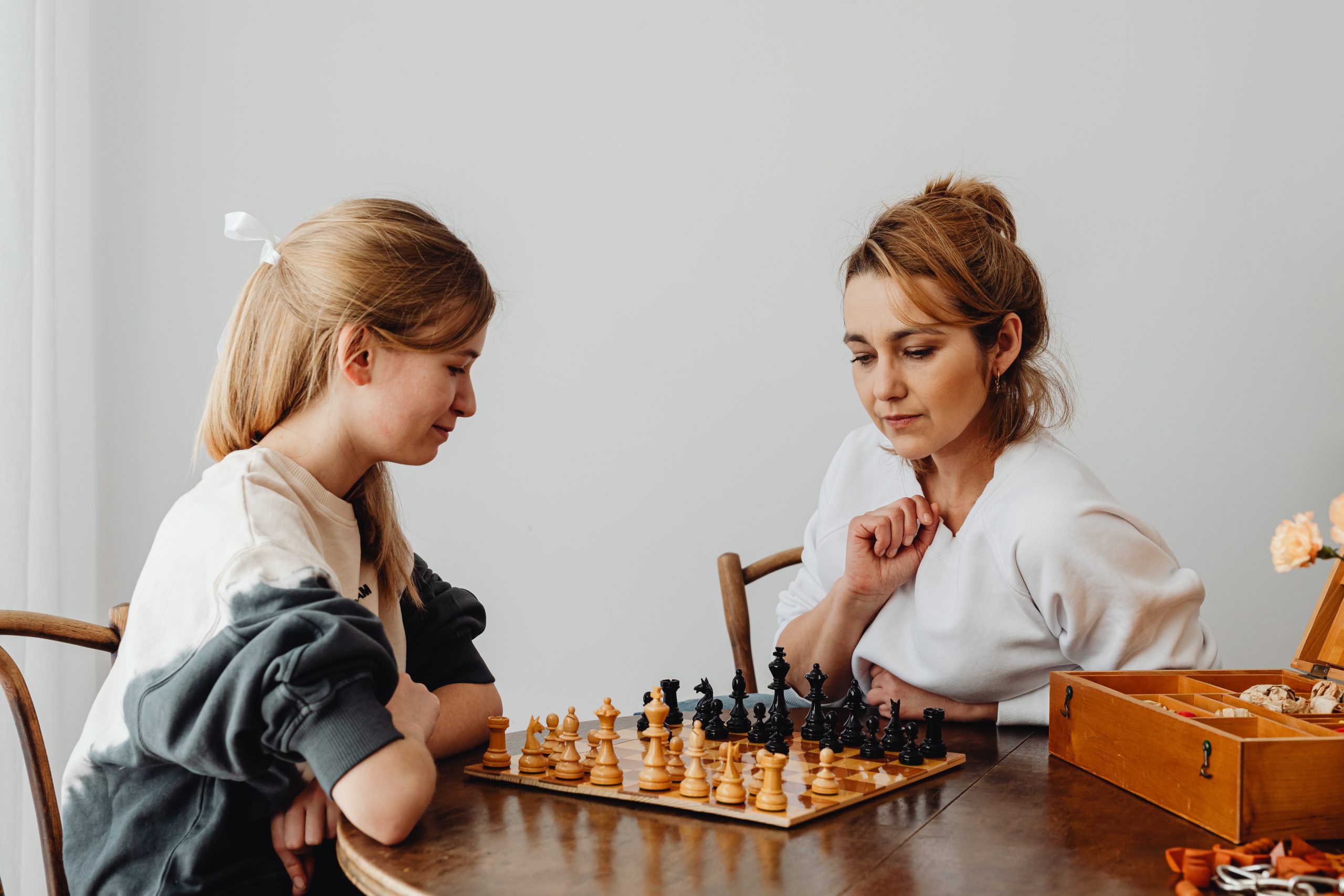 mother and daughter playing chess