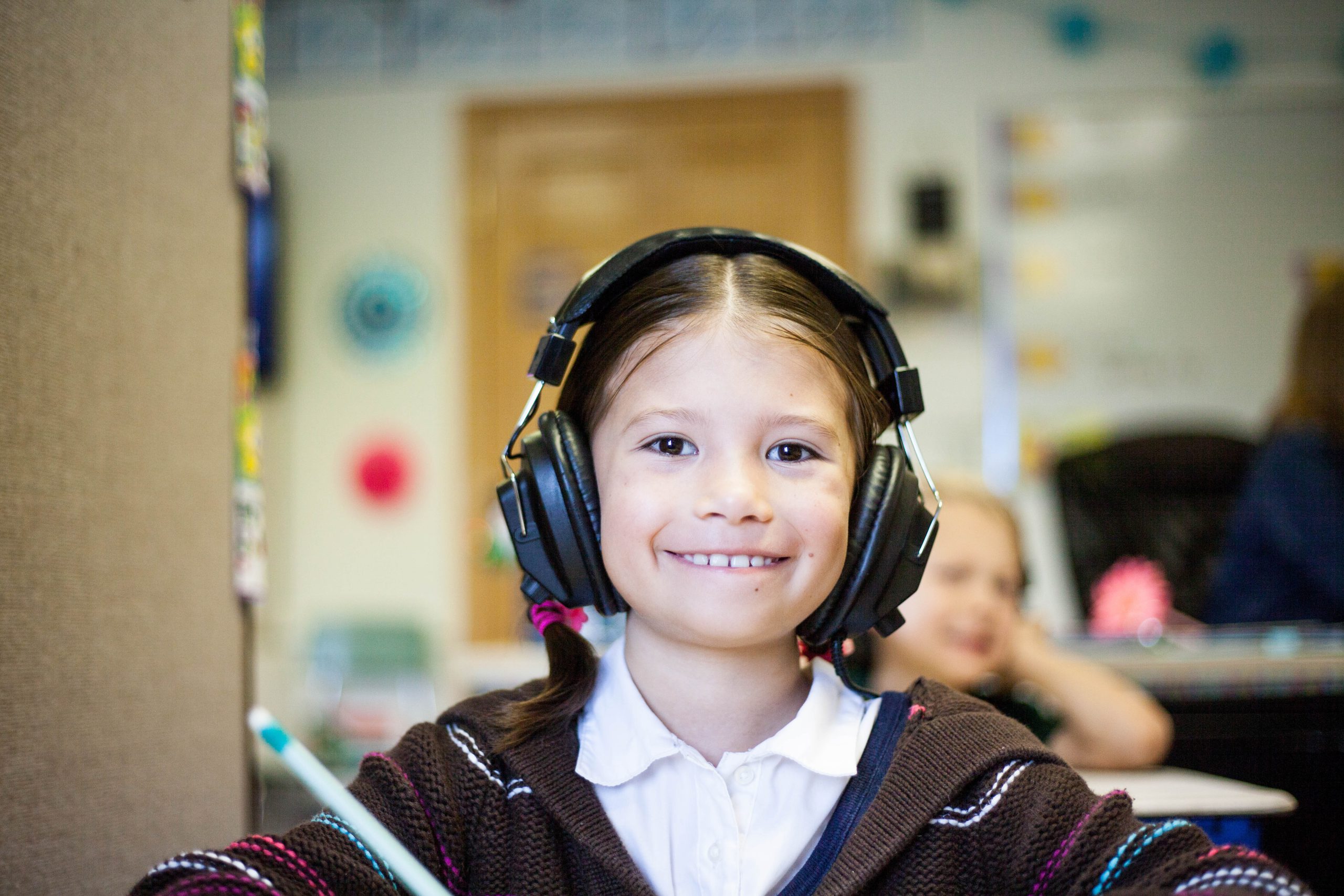 child with headphones smiling