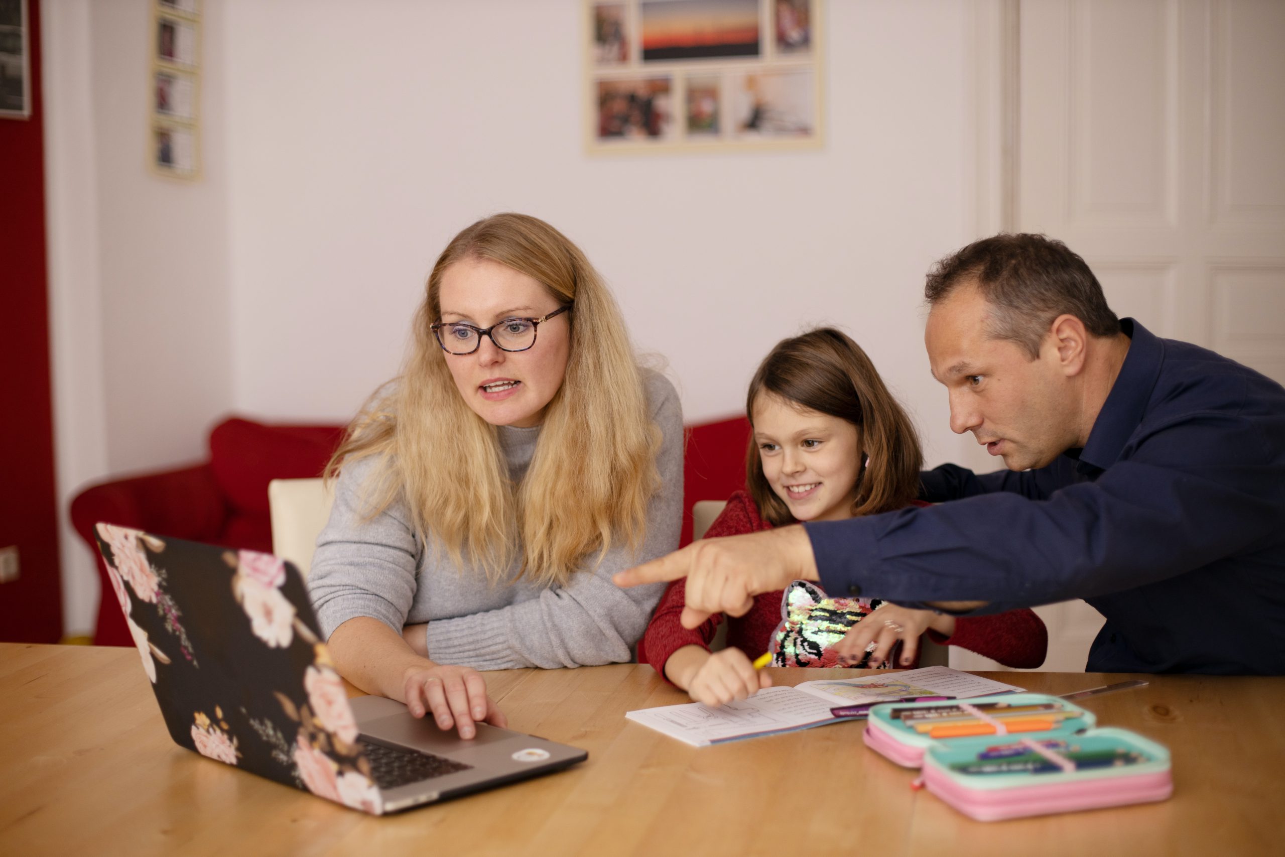 family around a computer, man pointing at screen