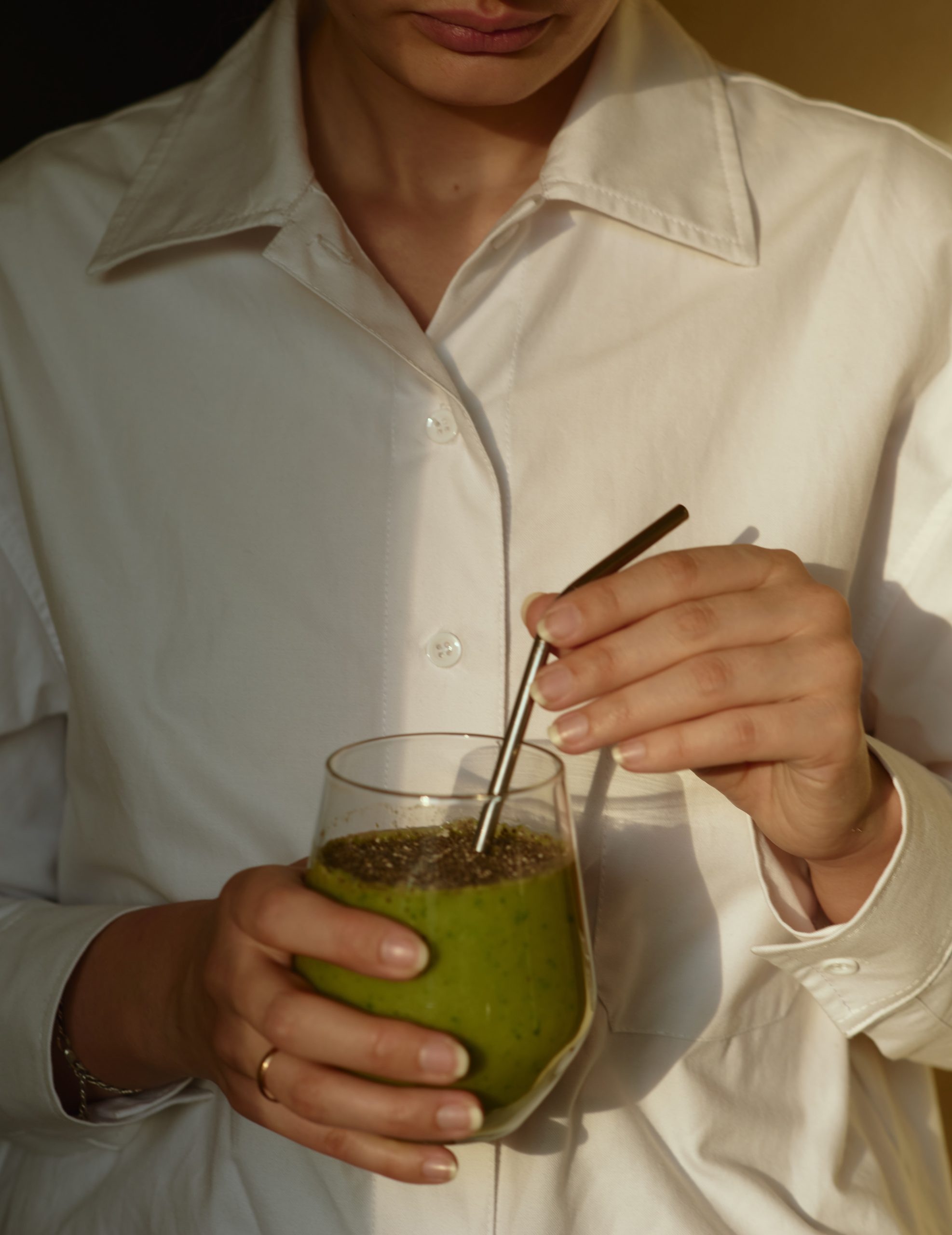 close up of woman with green drink