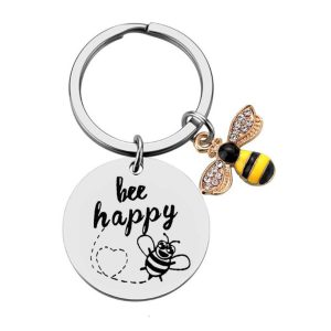 silver keychain with a yellow bumble bee that reads "bee happy"