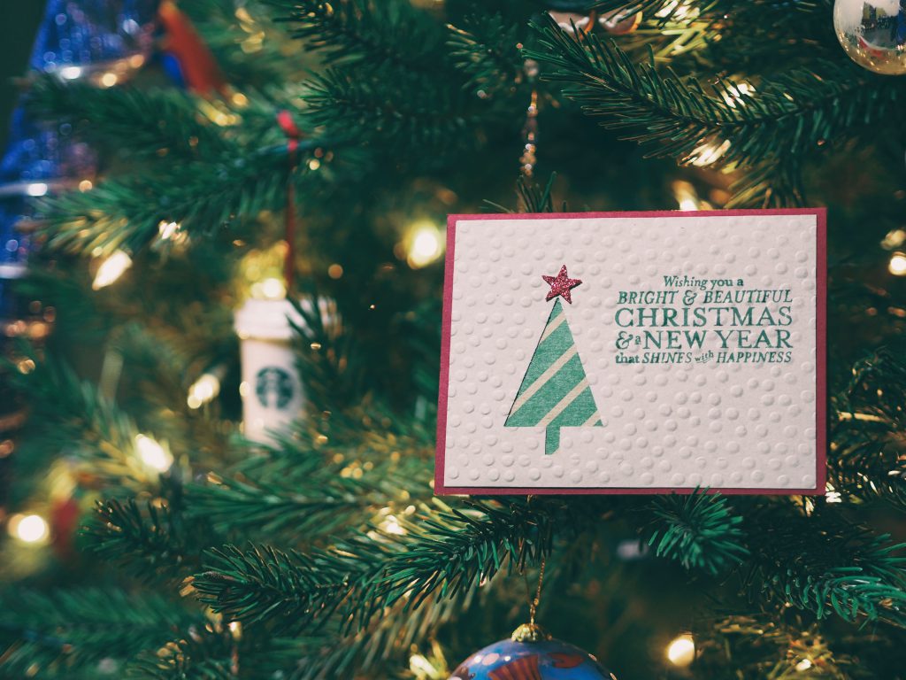 christmas card placed on a christmas tree