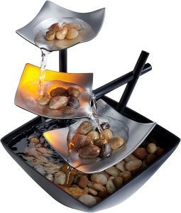small metal water feature with stones