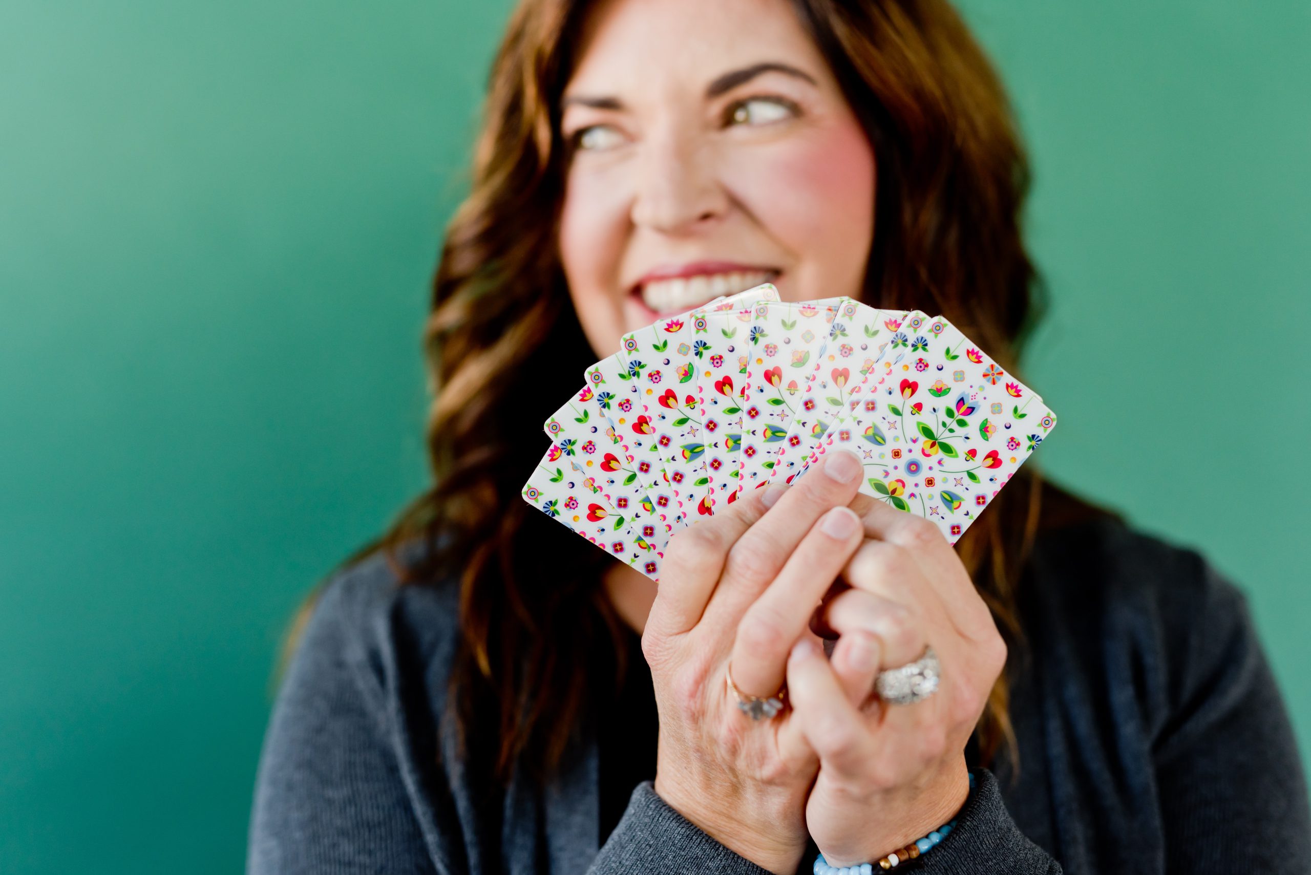 woman holding hand full of gift cards