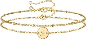 gold bracelet with multiple bands with a letter charm