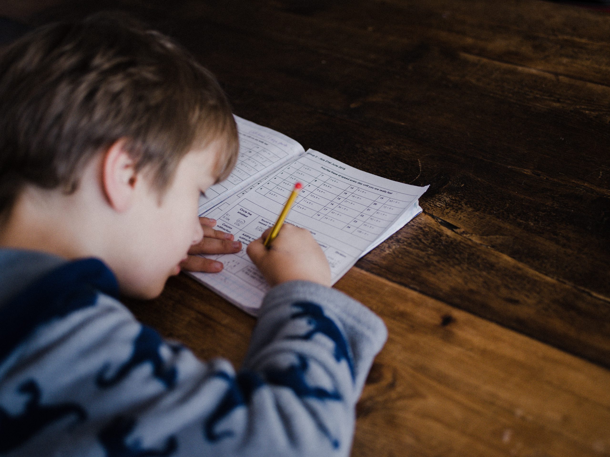 child writing in a workbook