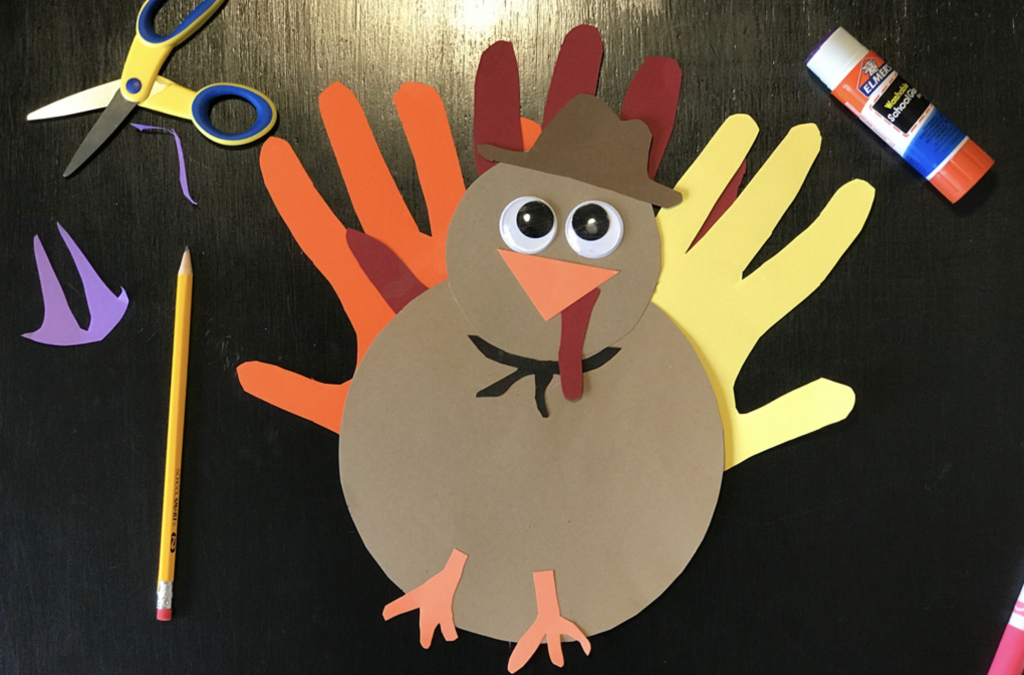 hand turkey craft with scissors and glue