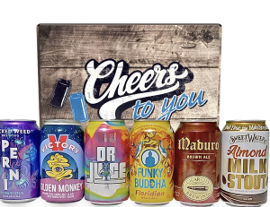 wooden crate that reads cheers, with six cans of beers lined up in front of it