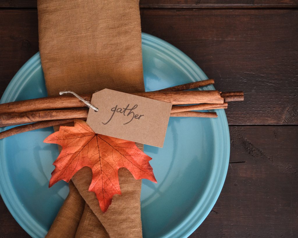 plate setting with a card that reads 'gather'