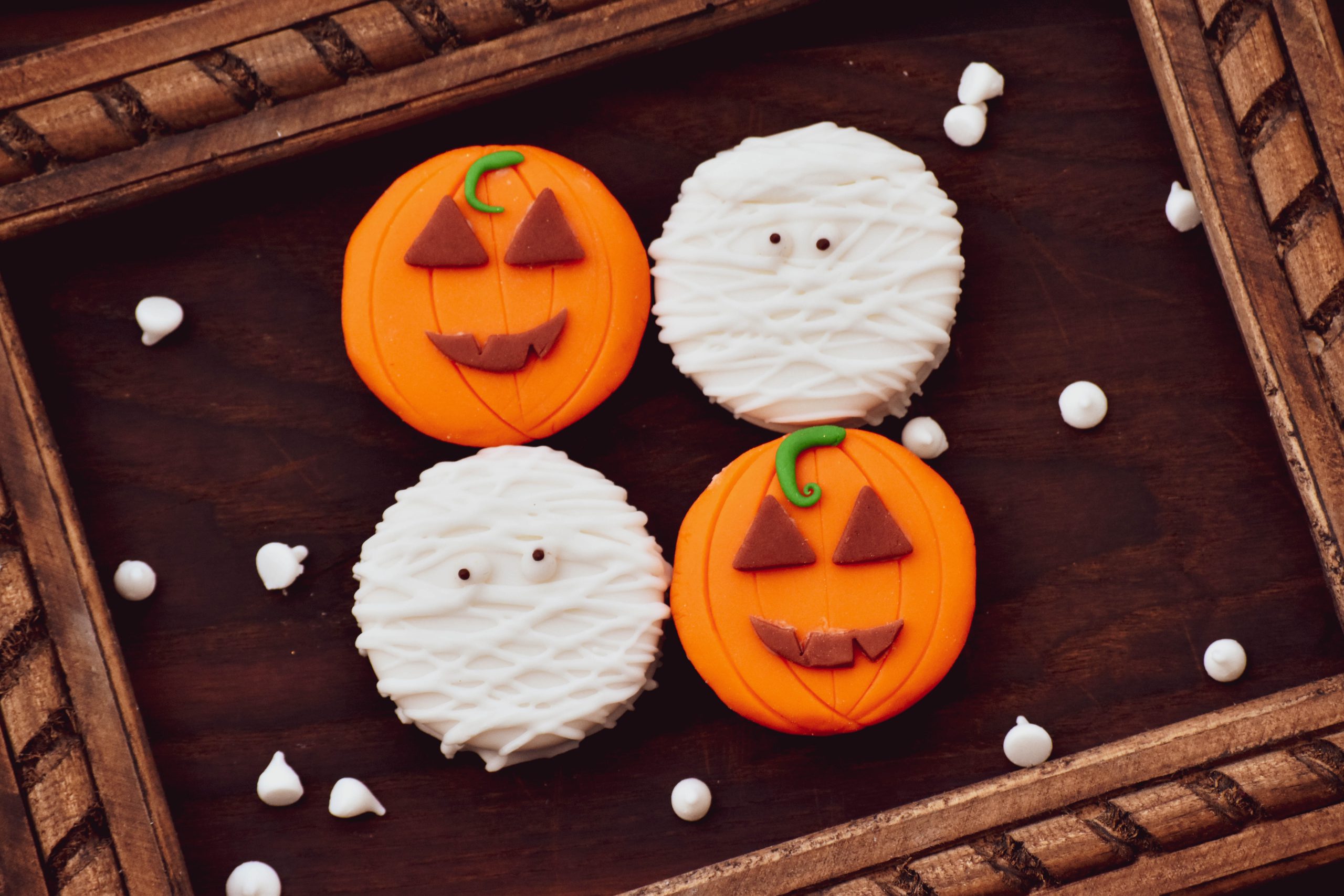 halloween cookies decorated as pumpkins and mummies