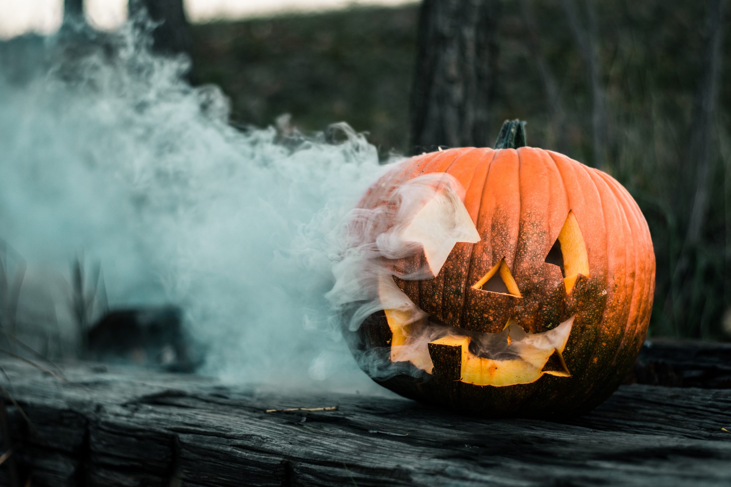 a carved pumpkin with smoke coming out of the holes