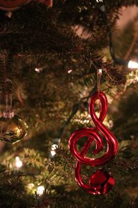 treble clef ornament hanging from a tree