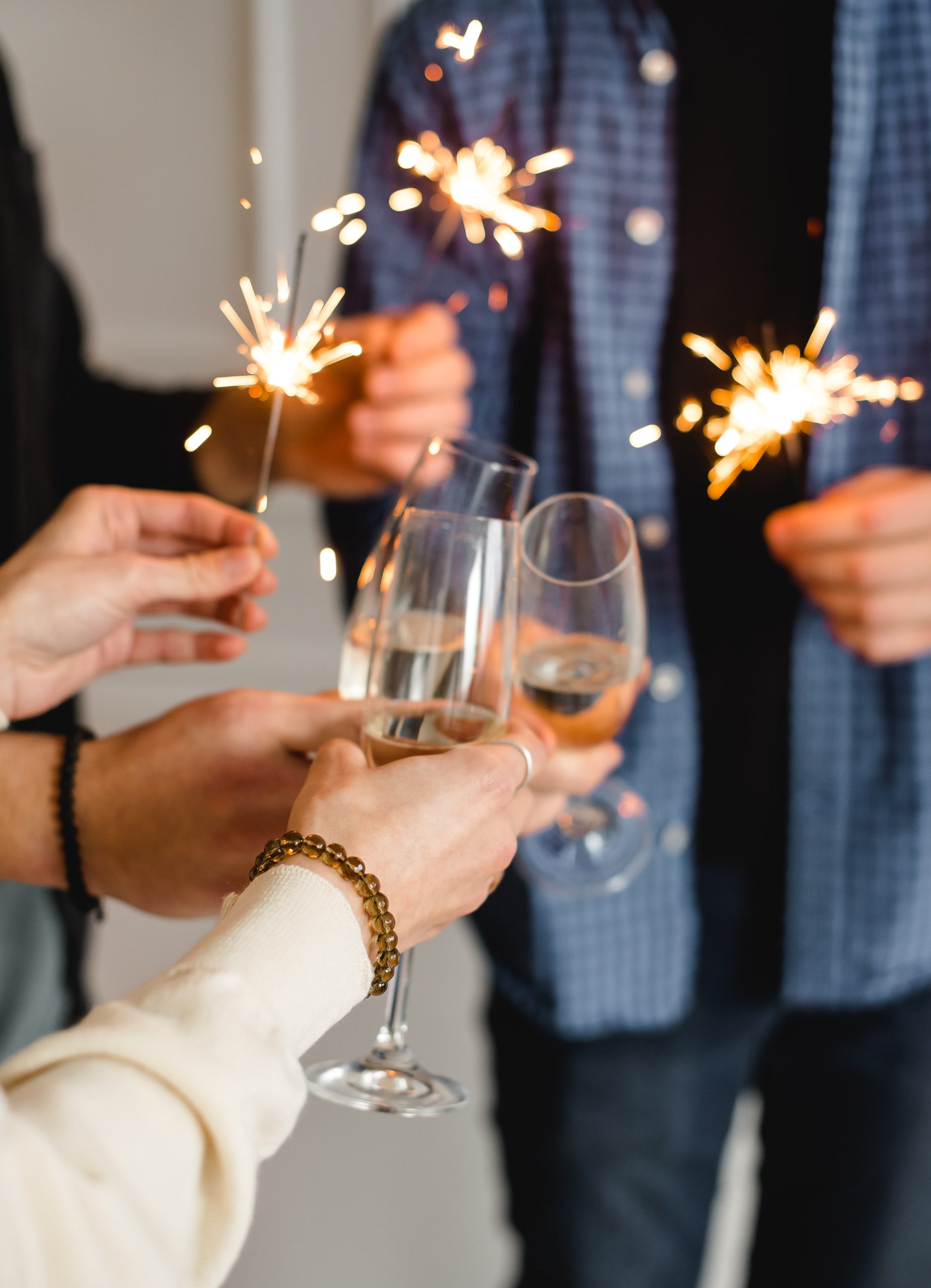 people holding sparklers and champagne glasses